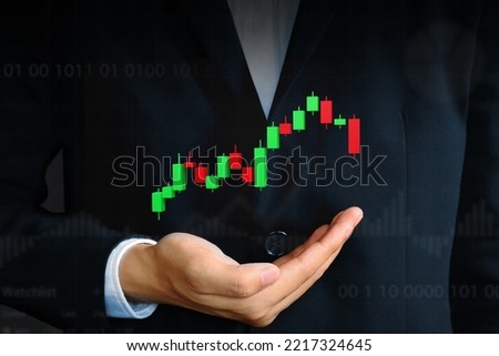 Professional Business investor shows 3d rendering Candlestick bar chart over hand, monitors stock market looking financial data, analyzing trend, concerned trading close-up. Stocks, Crypto, forex.