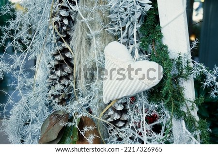 New Year and Christmas exteriors.  Christmas tree decorated with illuminations, garlands, toys, balls. Decorative heart made of cloth. DIY. 