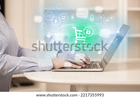 Hands working on laptop with digital icons