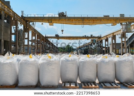 Big bags with calcium carbonate in yard of production plant