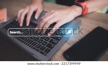 People hand using laptop or computor searching for information in internet online society web with search box icon and copyspace.