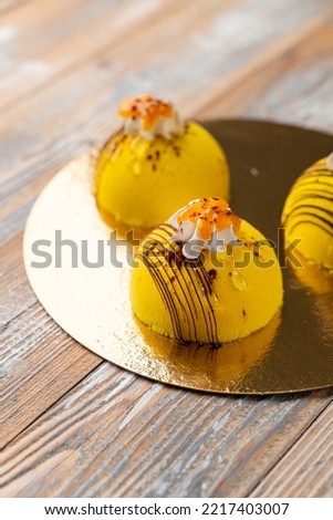 Yellow velvet patisseries on a golden tray