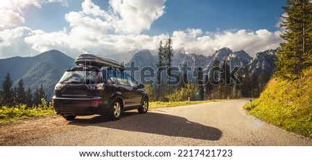 car for traveling with a mountain road. Blue sky Royalty-Free Stock Photo #2217421723