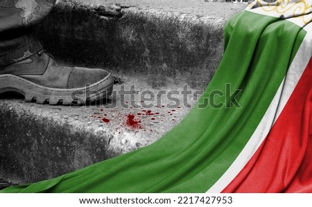 The leg of the military stands on the step next to the flag of Chechen Republic, the concept of military conflict
