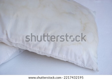 Closeup dirty pillows with saliva stains for long using, need to clean or change. Concept : unhygienic sleeping equipment, source of germs or dust mites that lead to get sick                          