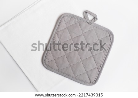 Pot holder mockup. Kitchen accessory. Cooking mitten. Flat lay. Royalty-Free Stock Photo #2217439315