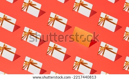 Isometric pattern of credit cards, gift cards, bonus cards. consumer concept, on a red background. Gifts for Christmas, Valentine's Day and birthday Royalty-Free Stock Photo #2217440813