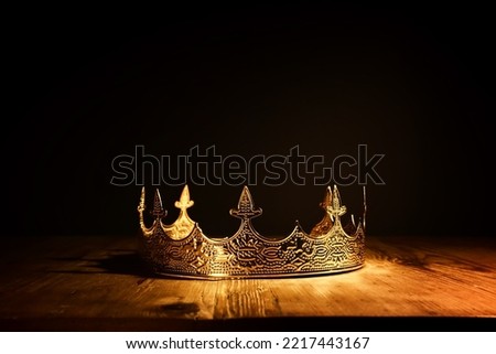 low key image of beautiful queen or king crown over wooden table. vintage filtered. fantasy medieval period Royalty-Free Stock Photo #2217443167