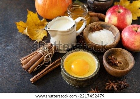 Autumn baking food background with pumpkins, apples, honey, nuts and seasonal spices on a stone table. Pumpkin or apple pie for Thanksgiving and autumn holidays. 