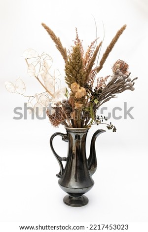 vintage gray teapot with dried flowers bouquet isolated on white background still life