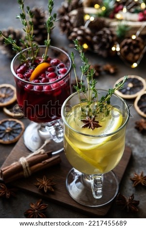 Christmas mulled  wine with addition cinnamon sticks, anise stars, cranberry and   oranges  in  glass  