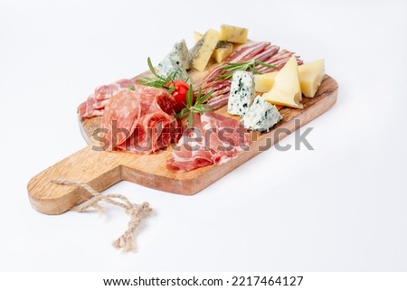 Appetizers table with different antipasti, charcuterie, snacks and cheese. Buffet party. Wooden cutting board isolated on white background, top view	 Royalty-Free Stock Photo #2217464127