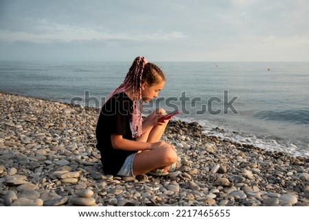 The girl sits and communicates online. Communication.