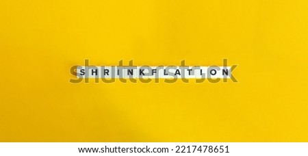 Shrinkflation or Package Downsizing Banner. Letter Tiles on Yellow Background. Minimal Aesthetics. Royalty-Free Stock Photo #2217478651