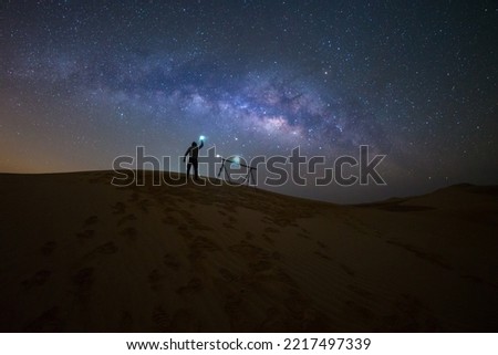 Photographer Camping in the sand dune desert  with milky way star of Abu Dhabi, UAE. Royalty-Free Stock Photo #2217497339