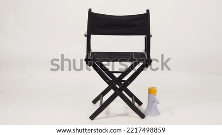 Back of Black director chair and megaphone on white background. Royalty-Free Stock Photo #2217498859