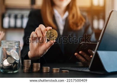 Business and Finance, Savings, Investing with Digital Assets, Future finance, blockchain. Business man holding golden Cryptocurrency hologram, bitcoinon financial growth chart.

 Royalty-Free Stock Photo #2217500409