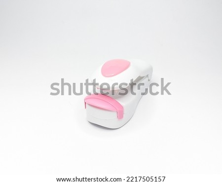 Mini portable hand heat sealer with heat isolated on white background.