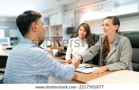Business with a customer by client service company commercial office. Female financial advisor consulting a client. Women have a business meeting and sign a contract or agreement on negotiations.