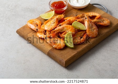 Close up of roasted prawn food on wooden seafood lime sauce