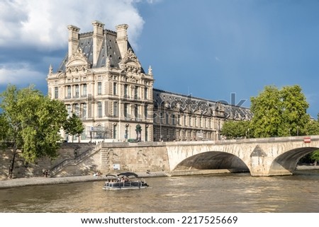Museum Louvre in Paris, France. View from Seine river Royalty-Free Stock Photo #2217525669
