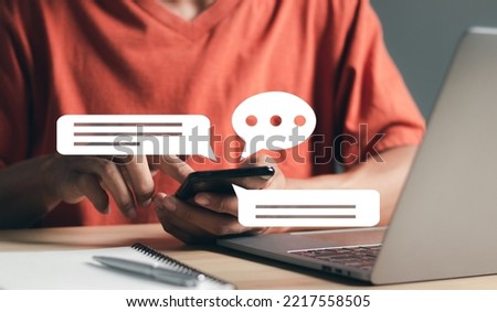 Social media marketing technology concept. Man using smartphone typing Live chat chatting and social network concepts, chatting conversation working at home in chat box icons pop up. 