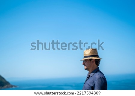 Caucasian man with a hat staring the landscape San Sebastian