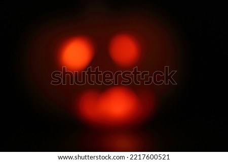 spooky concept - jack-o-lantern with burning eyes on dark background. Selective focus. Halloween concept