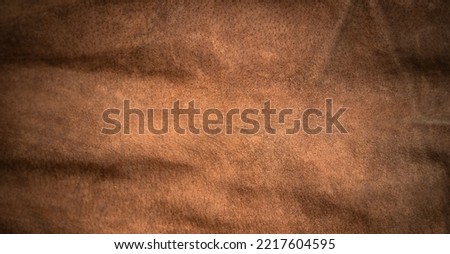 Photo of the texture of brown leather fabric. Brown textile background.