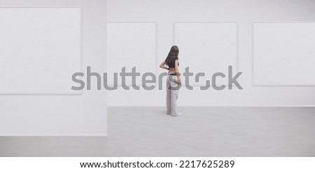 Young woman looking at the paintings at the art gallery, back view, copy space