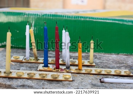 Unlit and partially melted colorful Hanukkah candles on a menorah during the celebration of the Jewish festival of lights in Israel. 