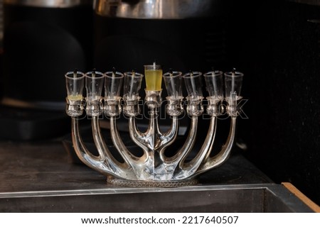 An unlit, silver Hanukkah menora stands idle during the daytime of the eight-day Jewish holiday also known as the Festival of Lights. 