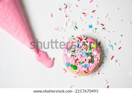 Top View of Cookies Decorated with Pink Frosting and Sprinkles