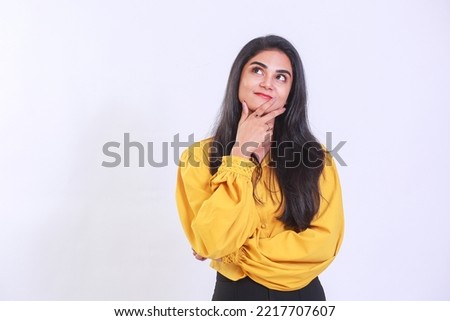 Closeup photo of amazing long hairdo lady looking up empty space deep thinking creative person arm on chin wearing yellow trendy top isolated on white color background