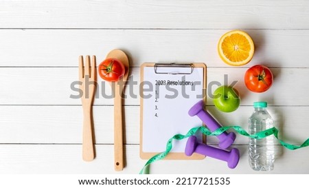 2023 Resolutions.  New year for New Changes Healthy.  Fresh vegetable fruits and healthy food for sport equipment for women diet slimming weight loss on white wood.  Healthy and Holiday Concept Royalty-Free Stock Photo #2217721535
