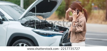 woman driver using mobile phone during problem car. Breakdown or broken car on road. Vehicle Insurance, maintenance and service concept Royalty-Free Stock Photo #2217735727