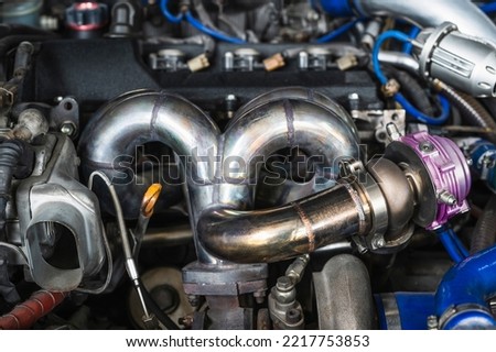 Welding fabrication stainless steel turbo and wastegate manifold header ,exhaust manifold in turbocharged racing car. Royalty-Free Stock Photo #2217753853