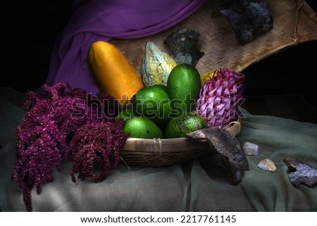 A collection of fruits arranged to form a good composition complemented by other objects on the table. Fine art photography. Light painting photography. Still life photography.                        