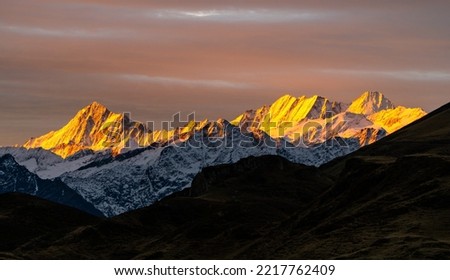 Sunrise with colourful snow peaks early morning in the Swiss alps, layers of mountains on a nice autumn day Royalty-Free Stock Photo #2217762409
