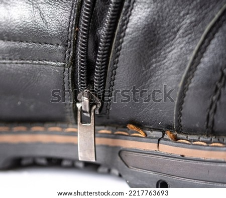 Old worn-out black shoe close-up