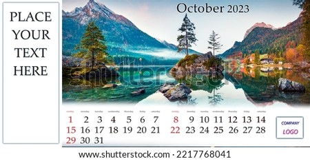 October 2023. Desktop monthly calendar template with place logo and contact information. Set of calendars with amazing landscapes. Beautiful autumn scene of Hintersee lake, Bavarian Alps, Germany.