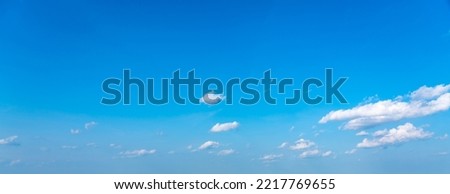 Blue panoramic sky background with small white clouds