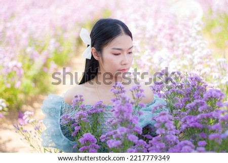 Beautiful asian take a picture in flower farm in udonthani