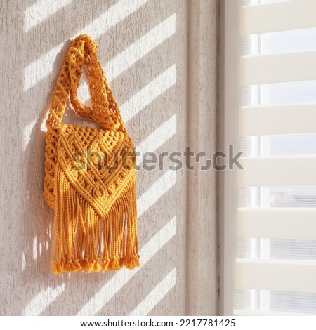Handmade macrame cotton сross-body bag. Eco bag for women from cotton rope. Scandinavian style bag.  Yellow color, sustainable fashion accessories. Details. Close up image