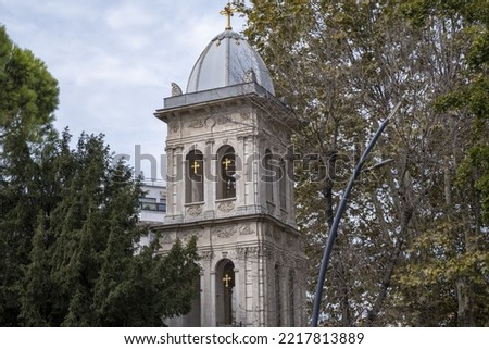 Church of Ayios Yeorgios Kuzguncuk Uskudar, church tower tower among trees, cloudy weather, old church in Istanbul Turkey, close up detailed Church of Ayios Yeorgios Royalty-Free Stock Photo #2217813889