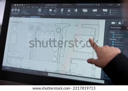 Room floor planner software close up, real estate studio project, interior design 2d creator app on computer screen. Apartment wireframes, woman pointing with finger on draft on monitor Royalty-Free Stock Photo #2217819713
