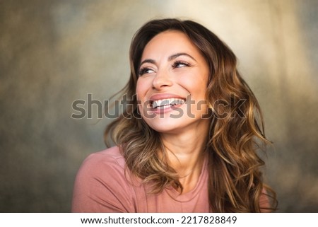 Close up portrait beautiful young woman smiling gazing Royalty-Free Stock Photo #2217828849
