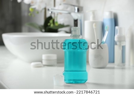 Bottle of mouthwash on white countertop in bathroom Royalty-Free Stock Photo #2217846721