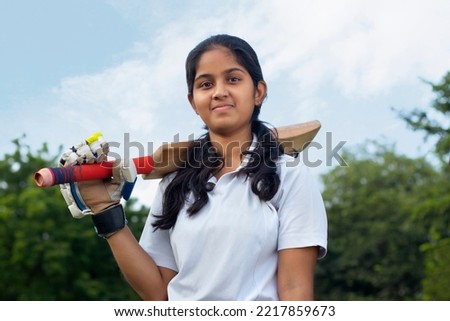 Portrait Of A Indian Female Cricketer Holding A Cricket Bat Royalty-Free Stock Photo #2217859673