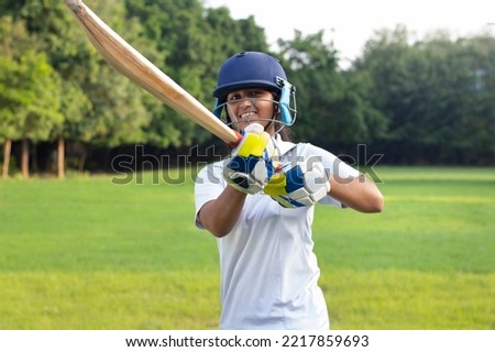 Portrait Of A Indian Female Cricketer Holding A Cricket Bat